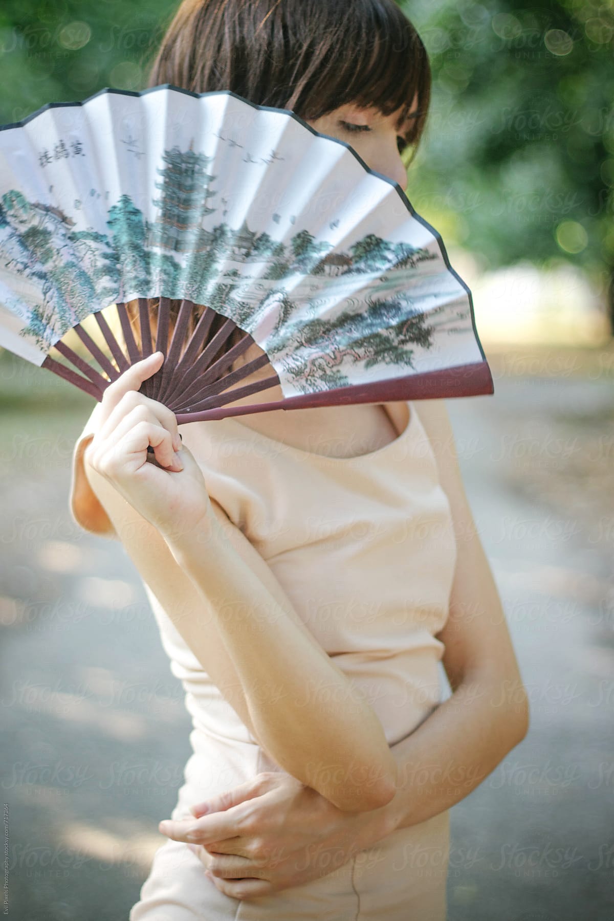 Portrait of a beautiful young female with lady fan