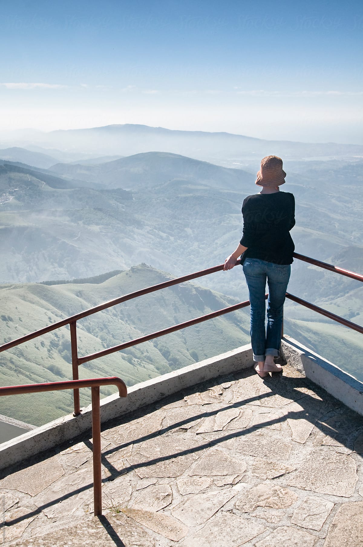 Young woman gazing at Pyrenees Mountains