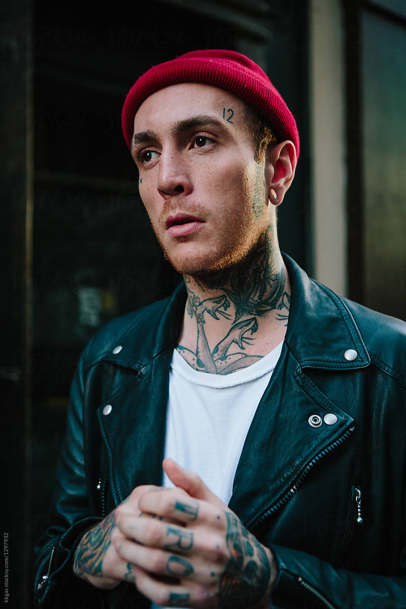 Punk man wearing leather jacket and beanie hat in London