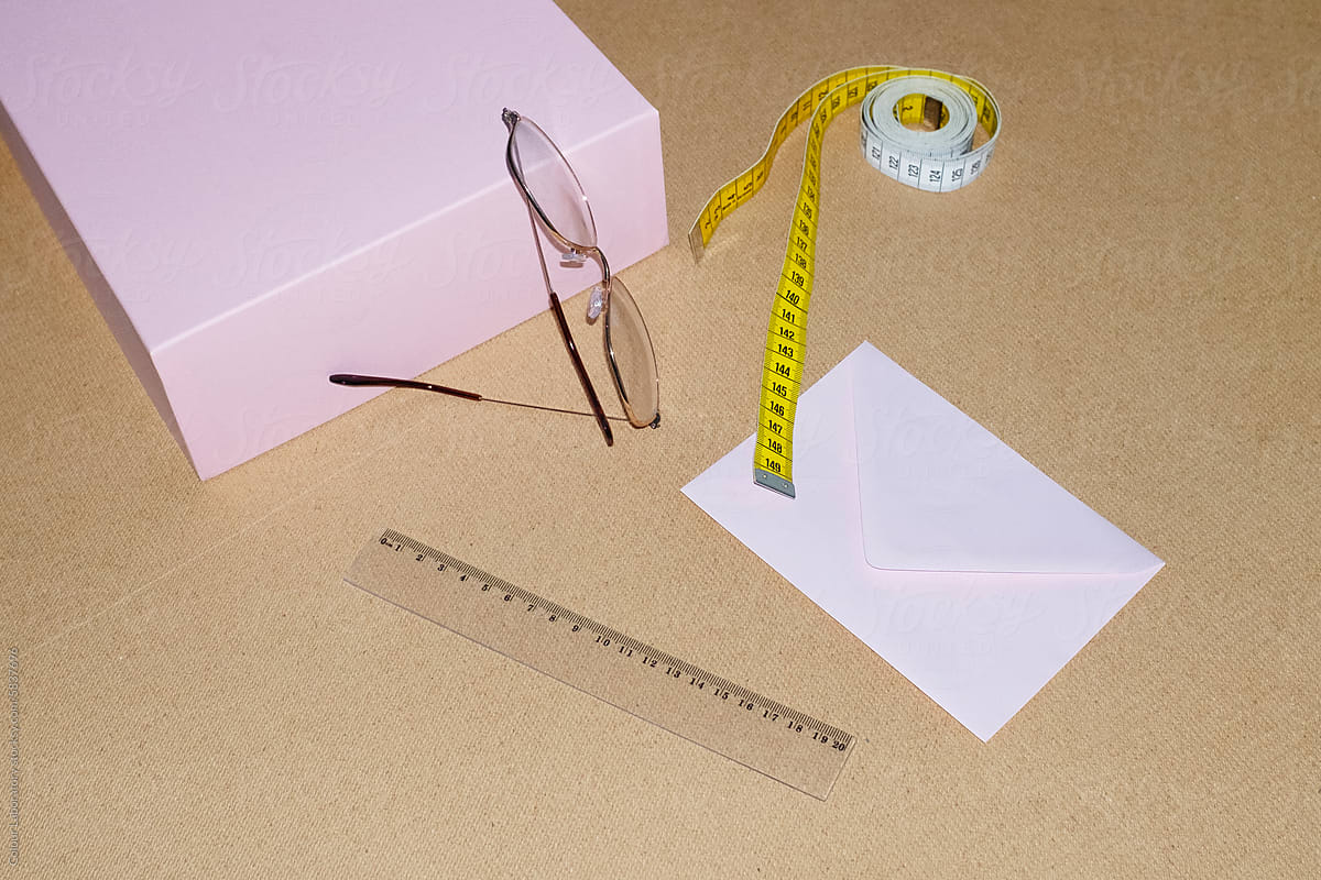 Office business desktop view with glasses, measurement tape, ruler