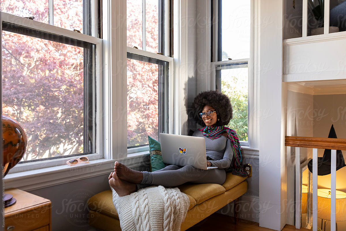 African American Lifestyle Girl relaxing at home with laptop computer