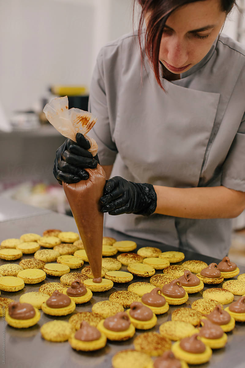 Woman making macaroons in bakery
