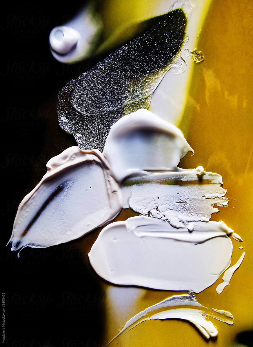 Face Cream Smudges on Yellow and Black Background