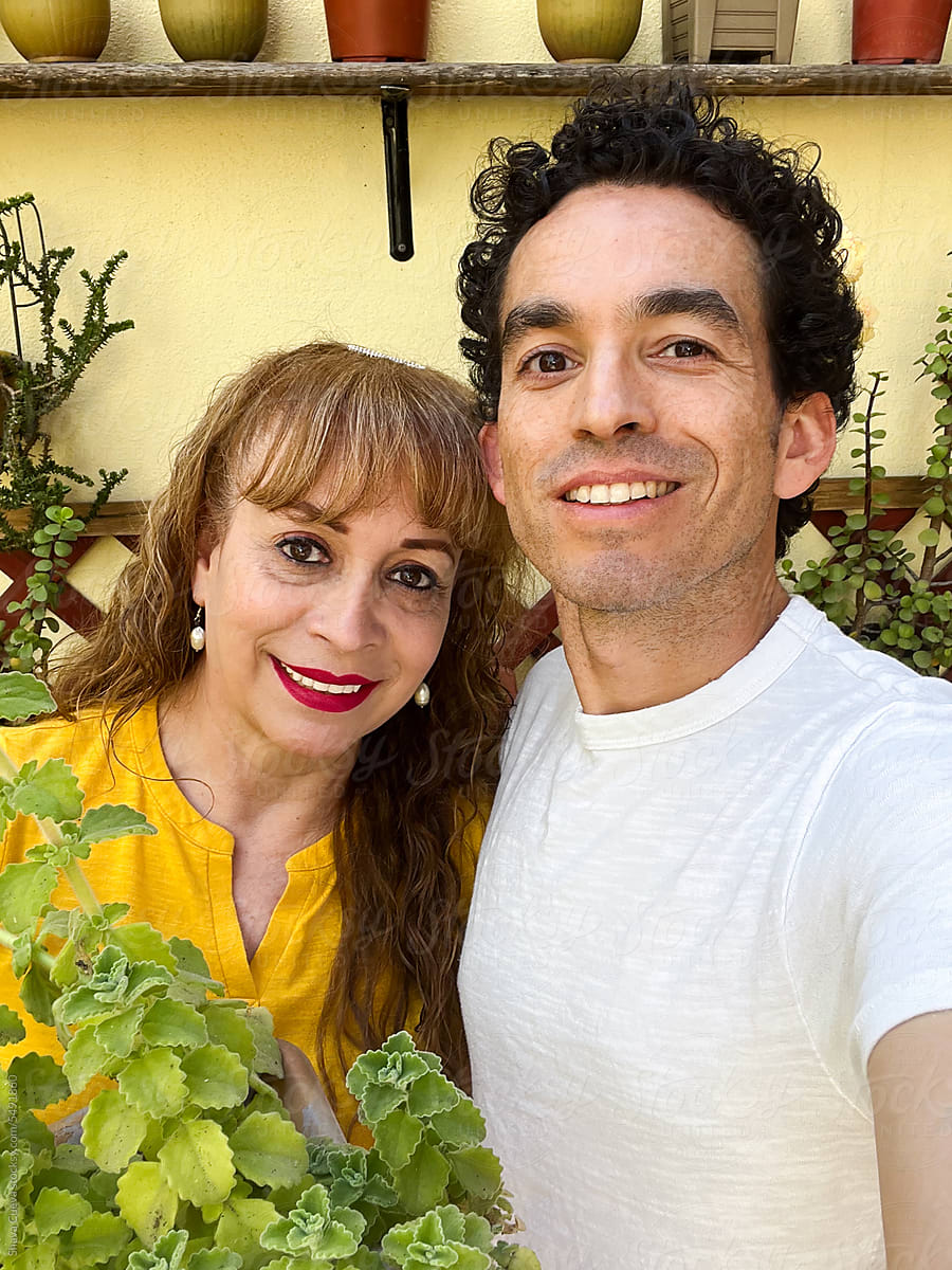 Selfie of a mom and her son smiling with a plant