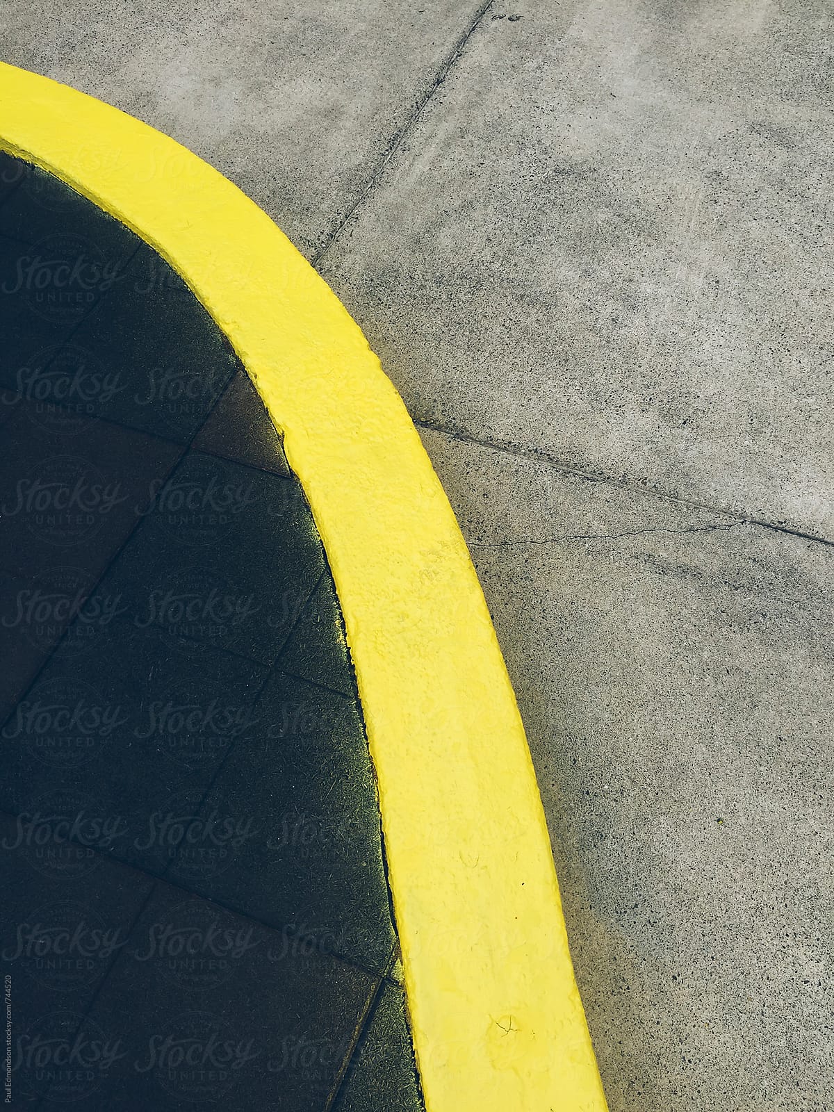 Painted yellow curb and urban sidewalk