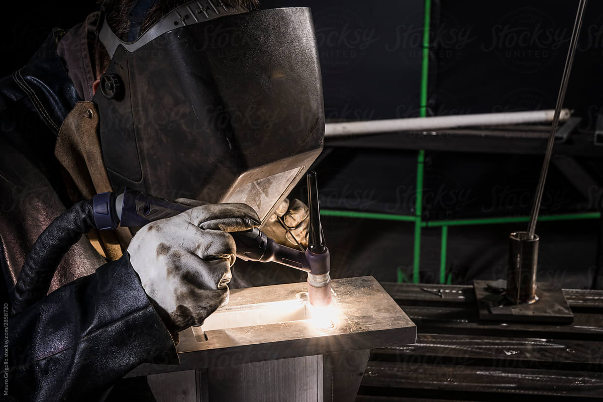 Man welds in his workplace