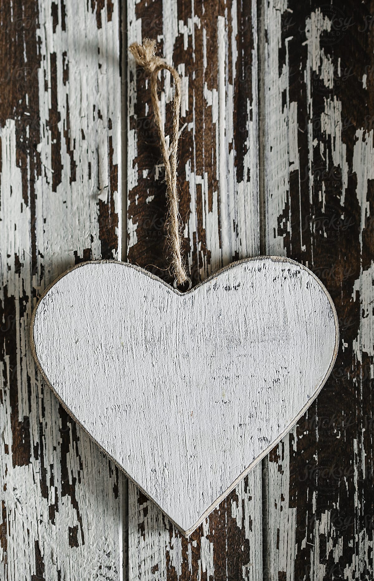 Wooden love heart on wooden background.