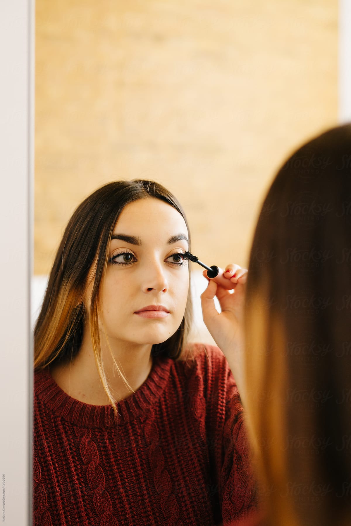 Woman putting mascara makeup