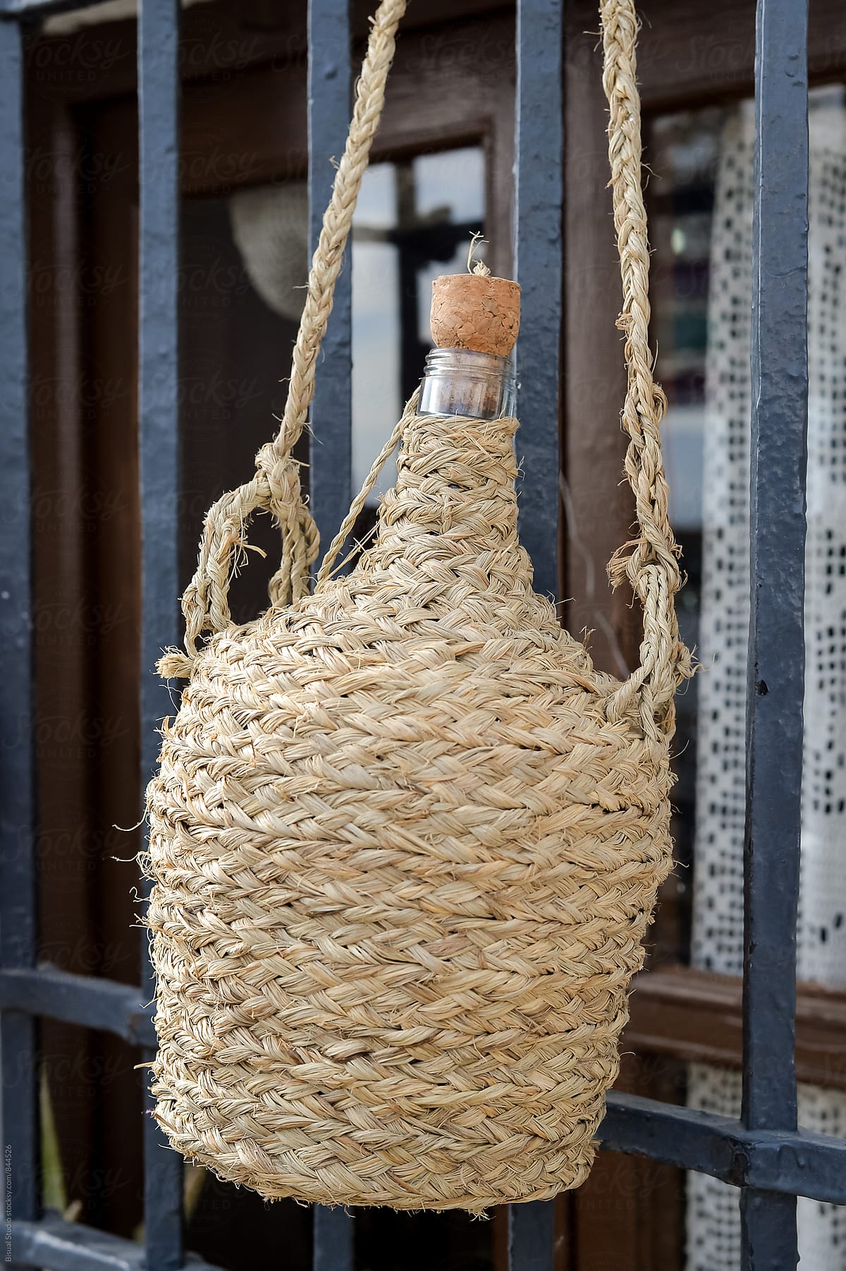 Typical andalusian demijohn with a cover made of straw