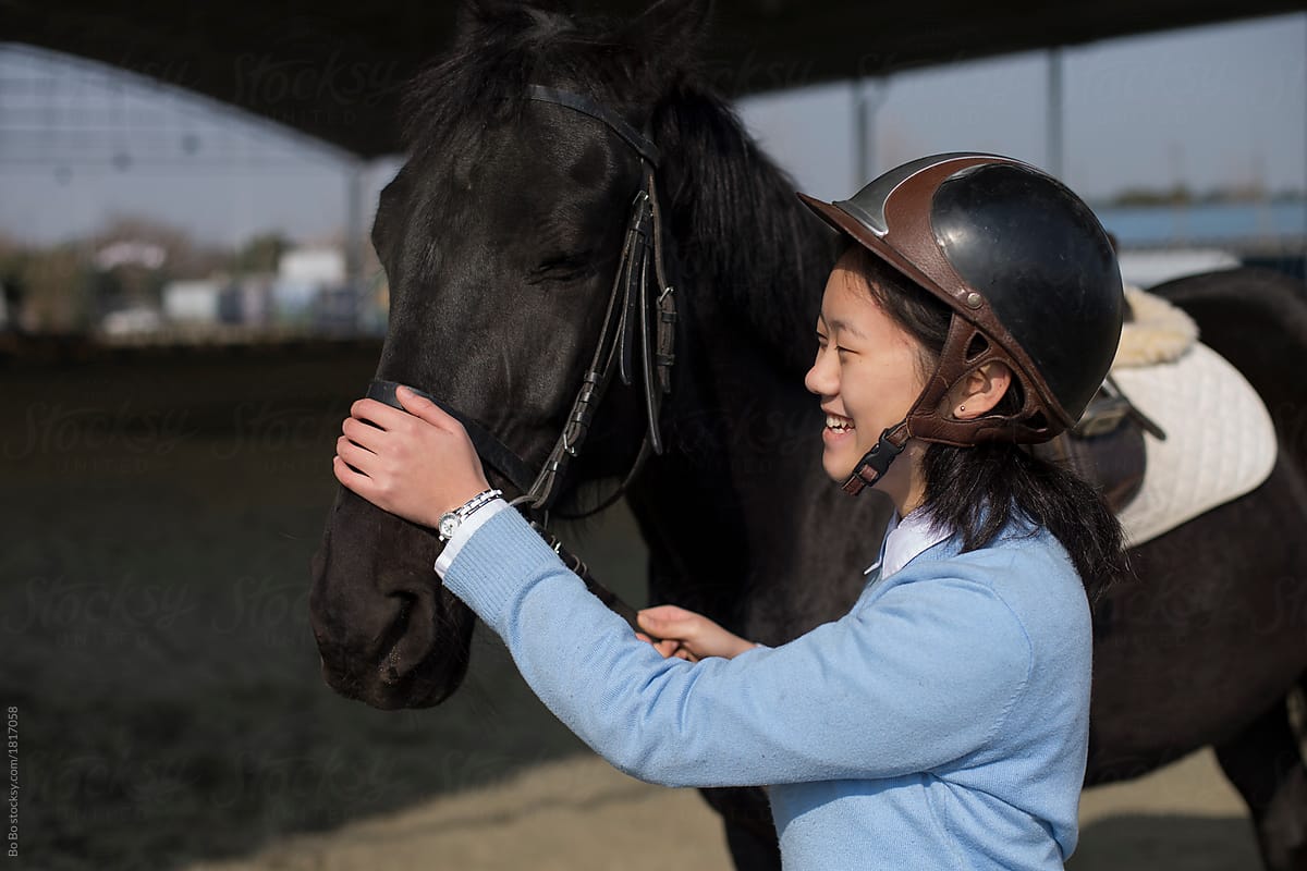 happy young asian woman with her horse