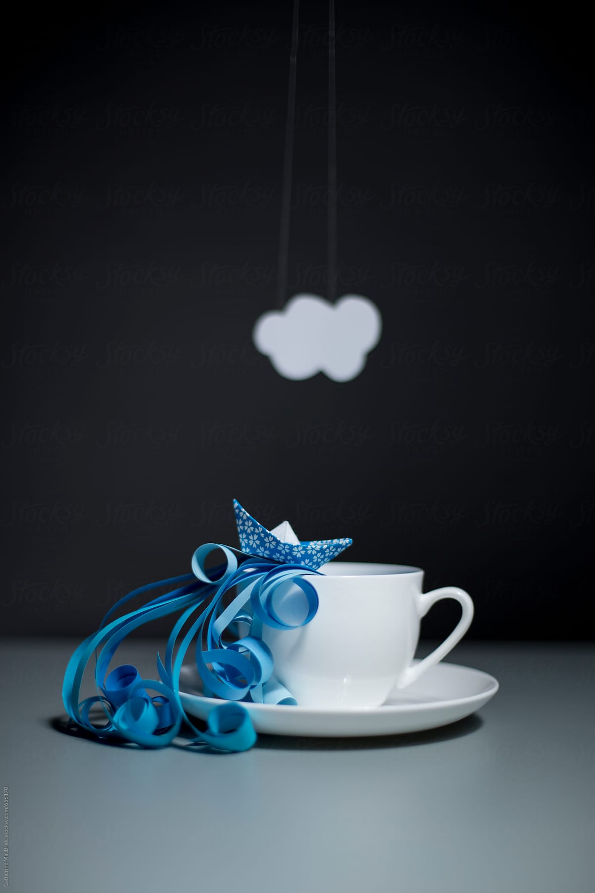 Paper craft storm in a teacup with waves, boat and cloud