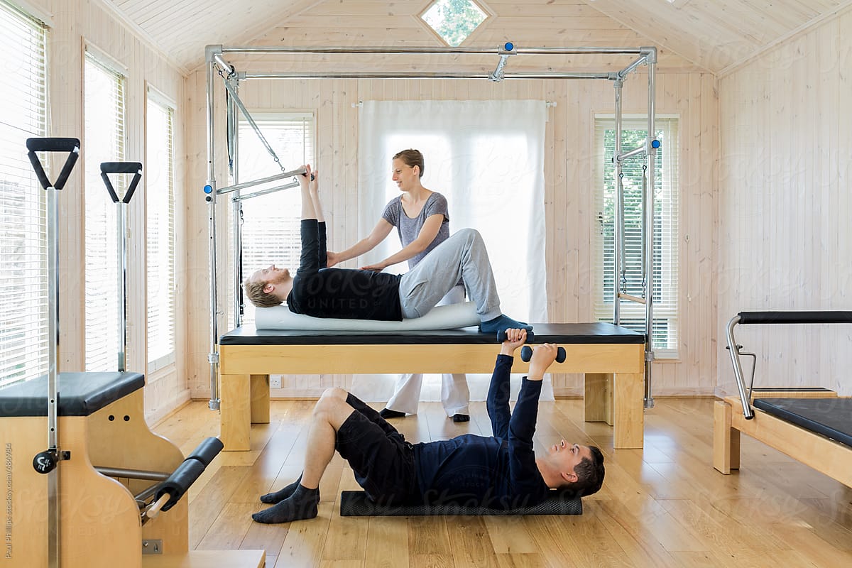 Pilates stability roll with hand weights and with the push through bar on the Cadillac