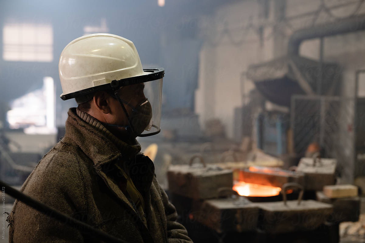 Foundry worker in helmet and mask