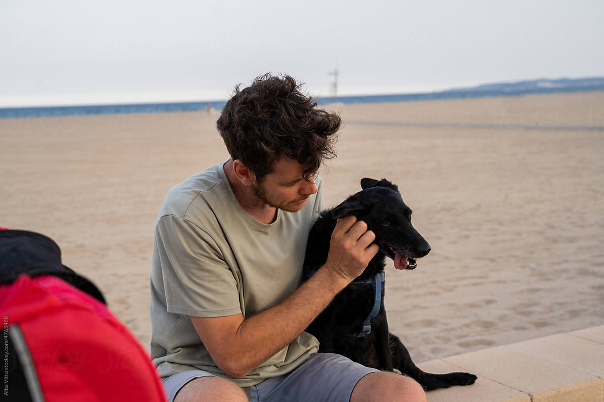 Man with dog at beach