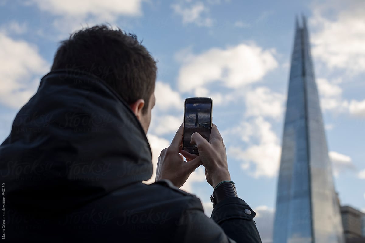 A male tourist takes photos in London
