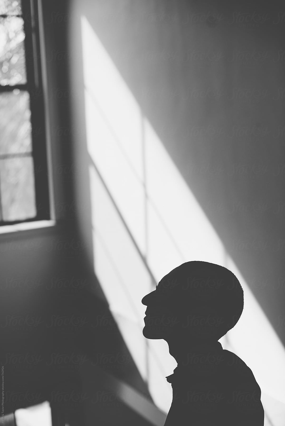 Silhouette of man by window