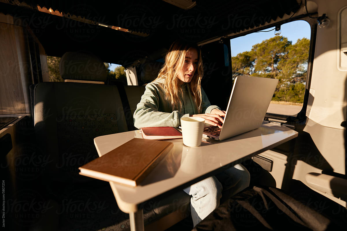 Female freelancer working in camper van