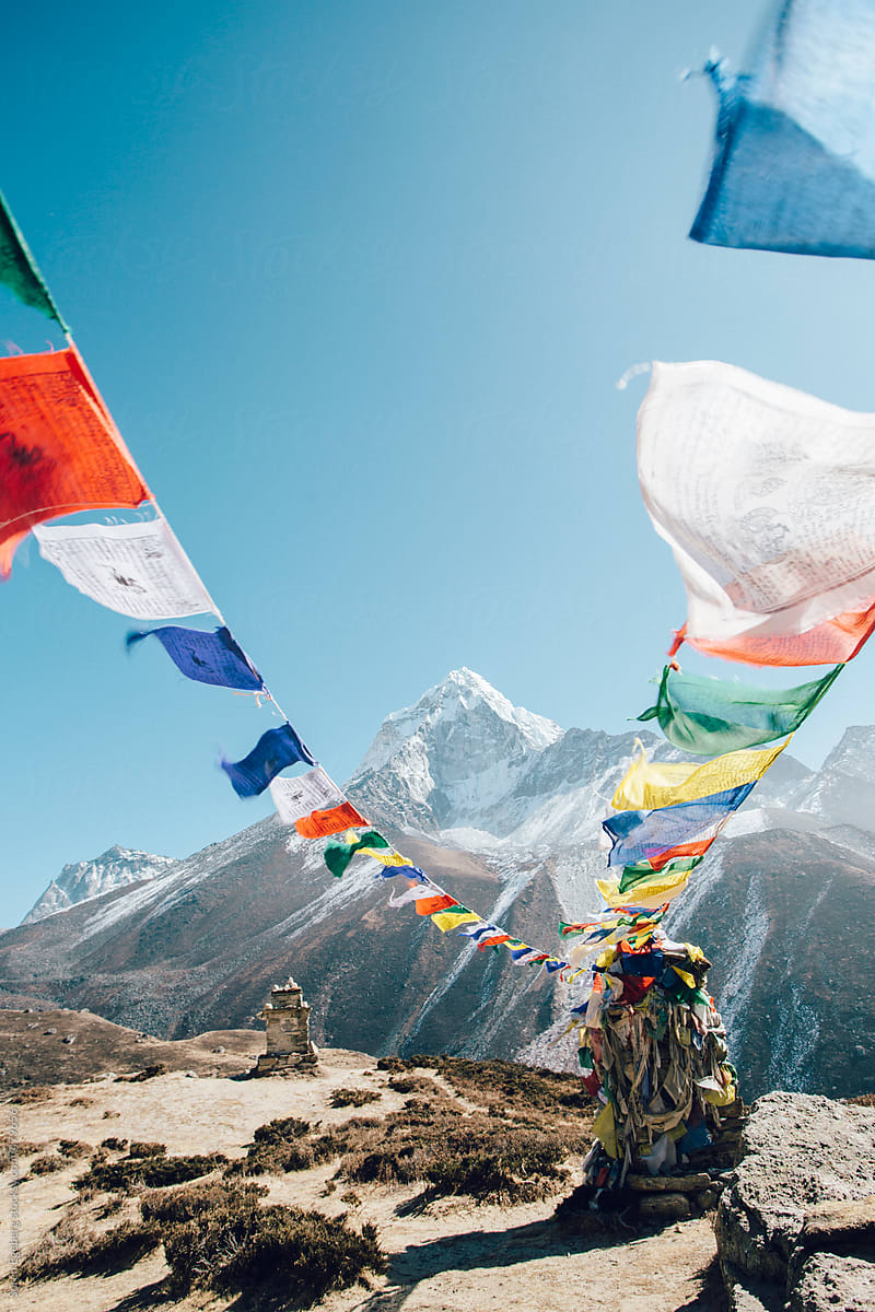 Closeup of Buddhist prayer flags blowing in the wind from a stupa high in the Himalaya mountains.