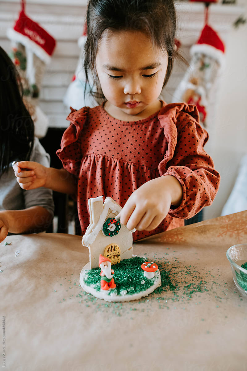 Girl Decorating a House on Christmas