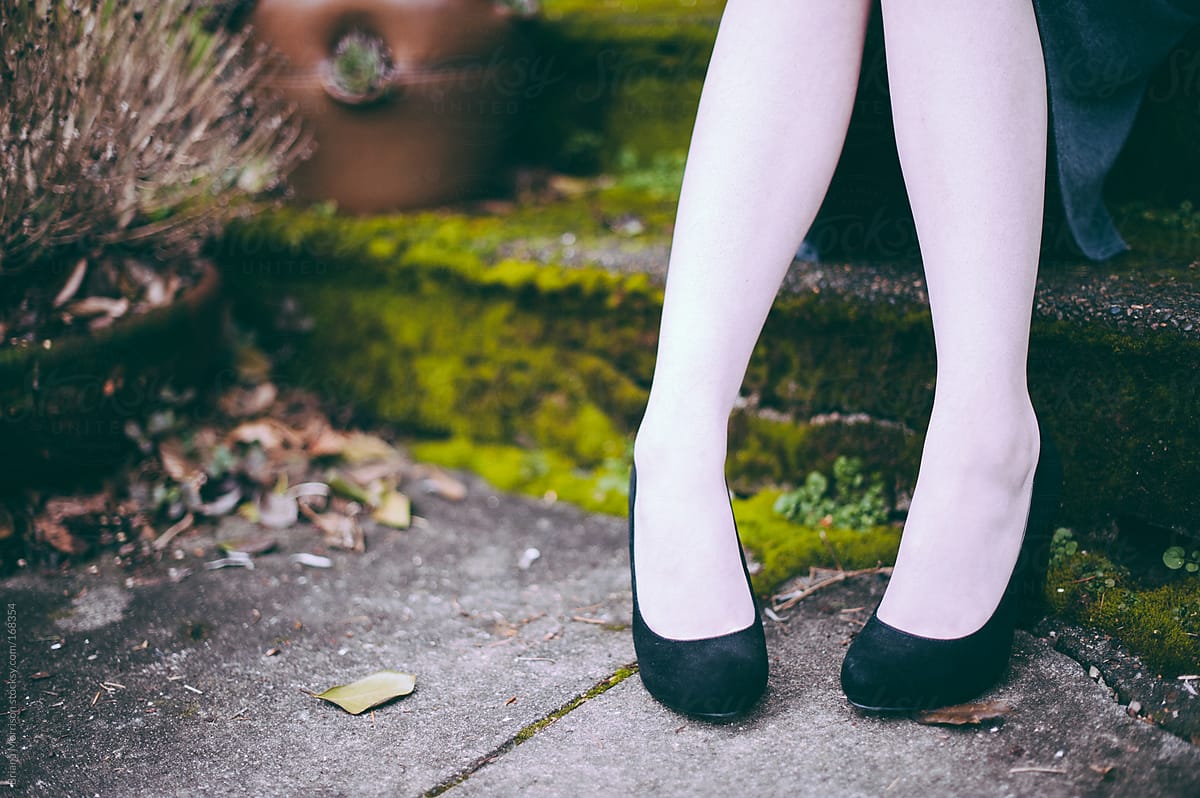 Feet in Black High Heels and White Stockings Outside