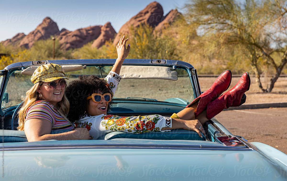 Happy Friends Talking in Vintage car on road trip