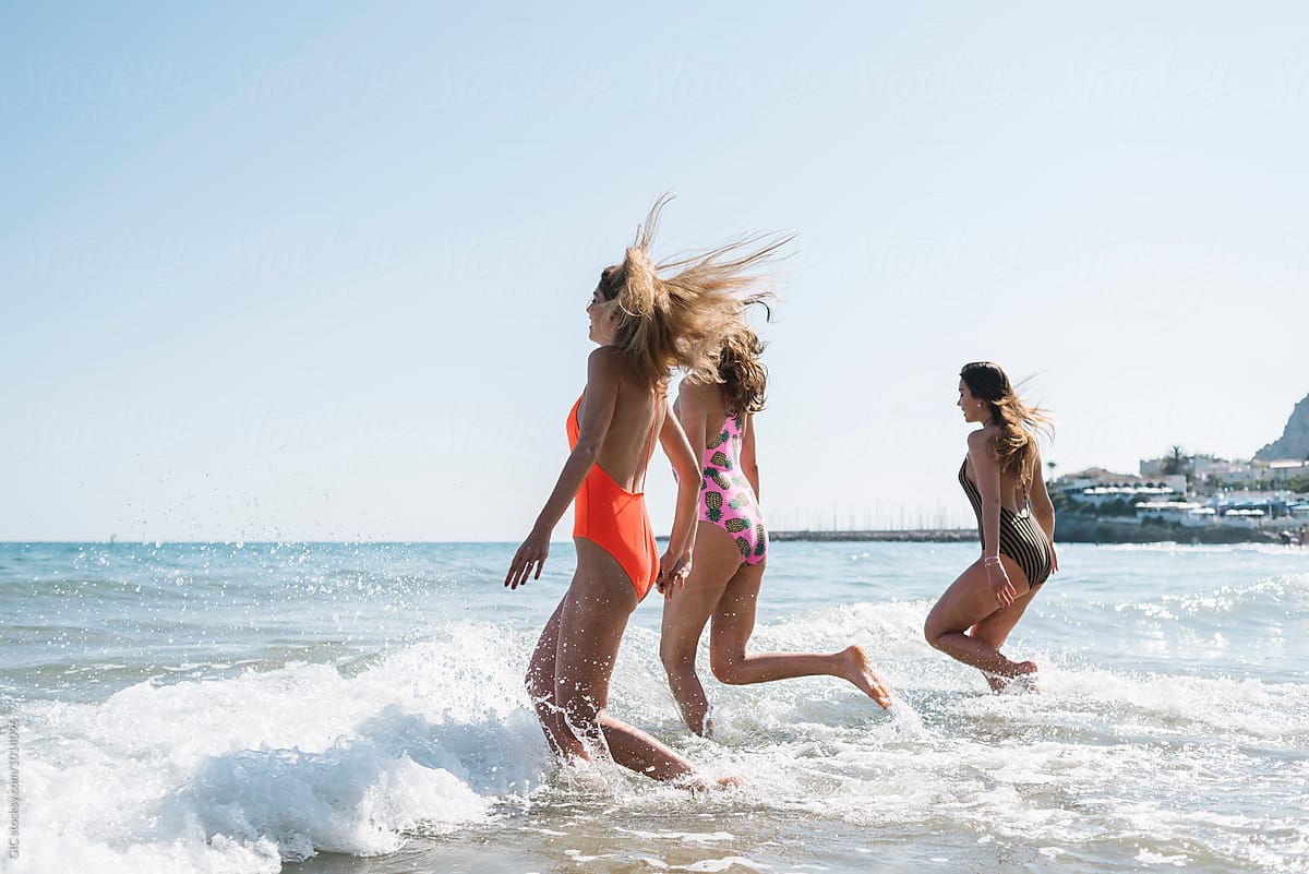 Three Girls Running In The Sea By Stocksy Contributor Simone Wave