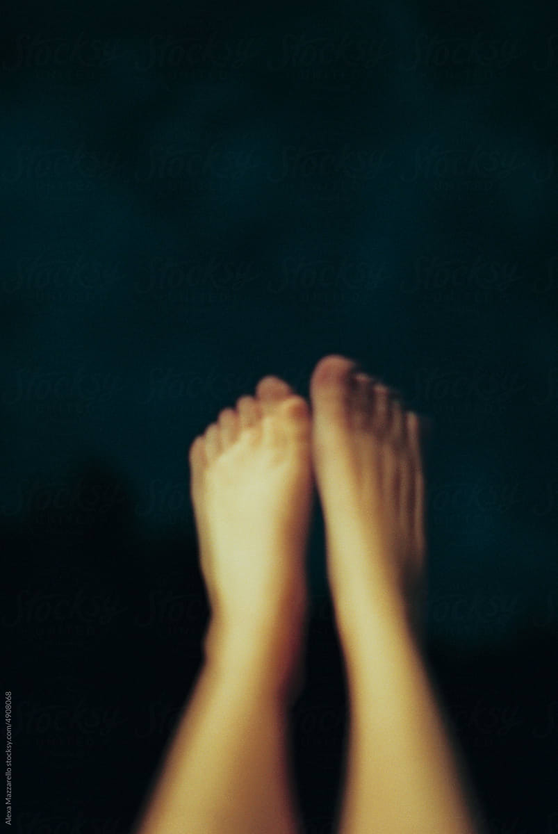 Blurry image of woman\'s feet in the air