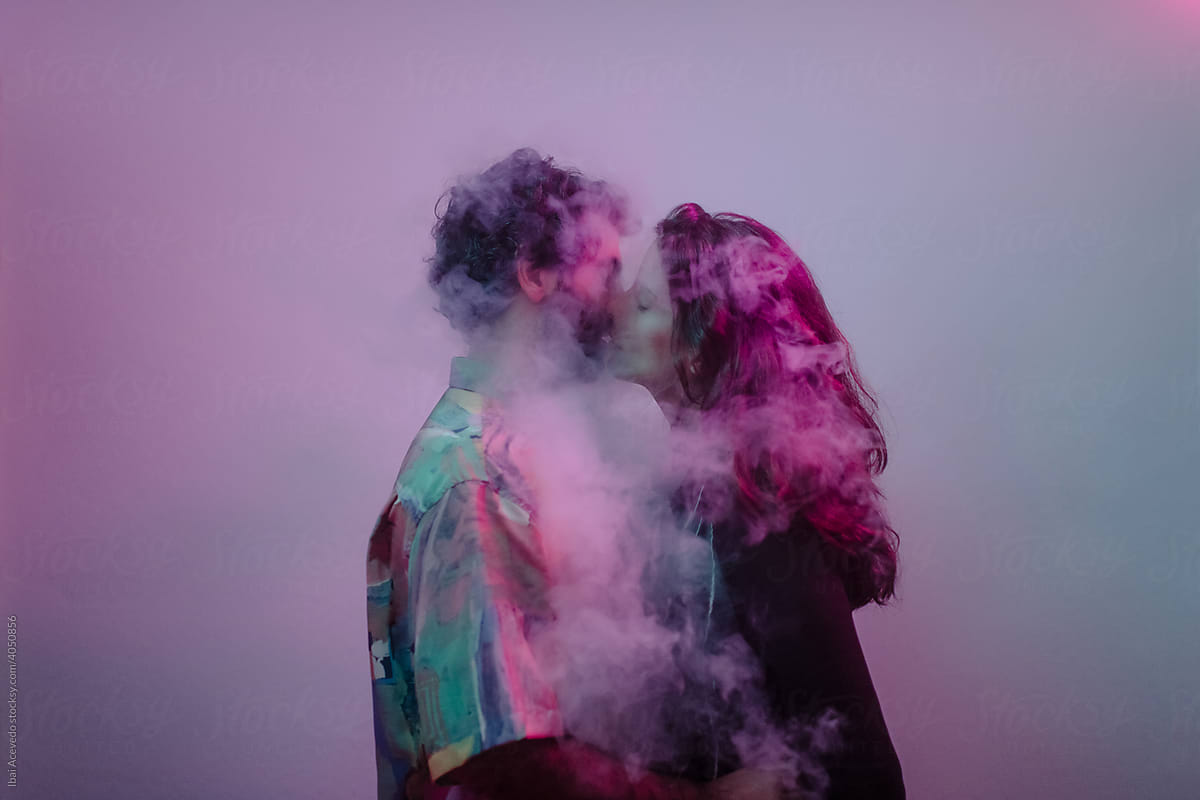 Kissing couple inside smoke cloud