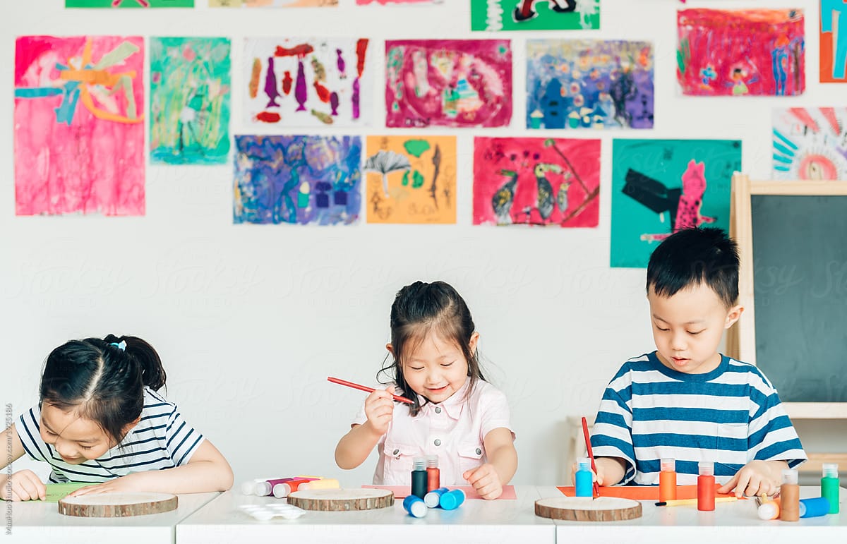Preschool kids painting in classroom