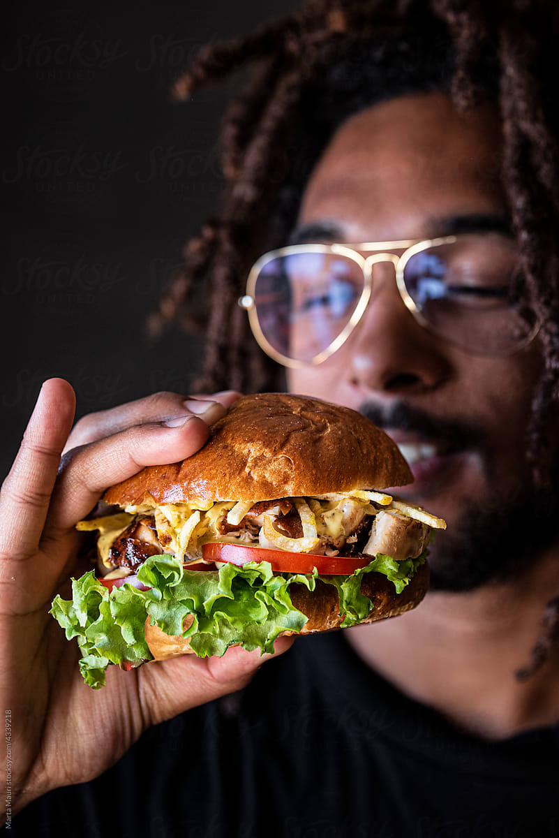 Man holding a Chicken Burger