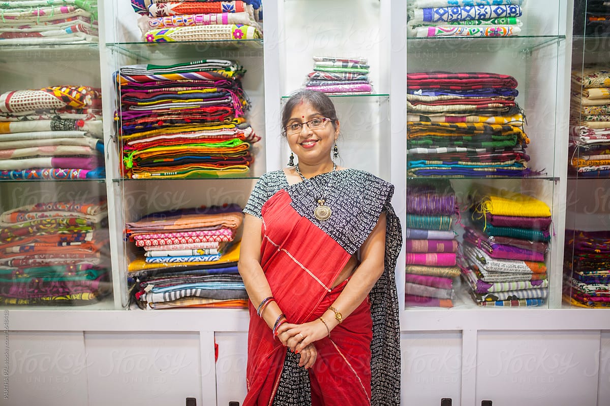 A Businesswoman Who Sells Traditional Indian Dress In A Small Shop By