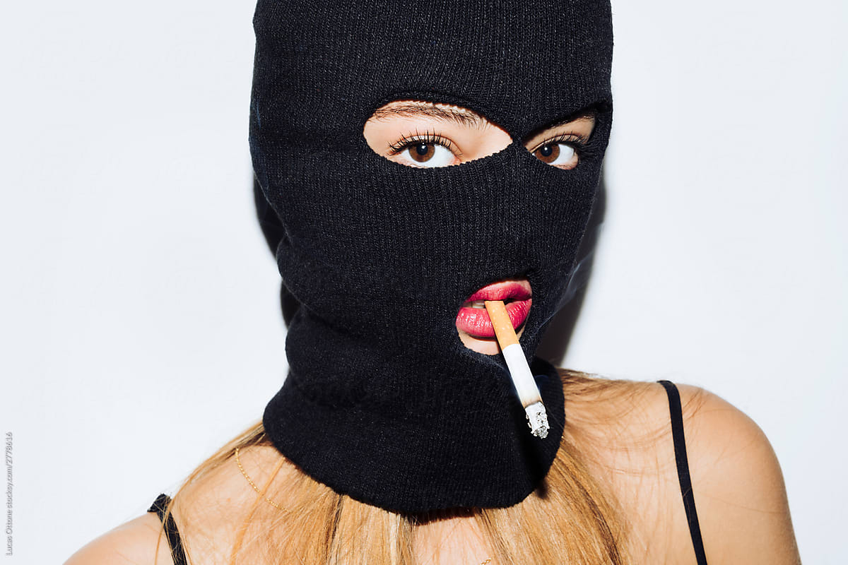 Masked woman smoking