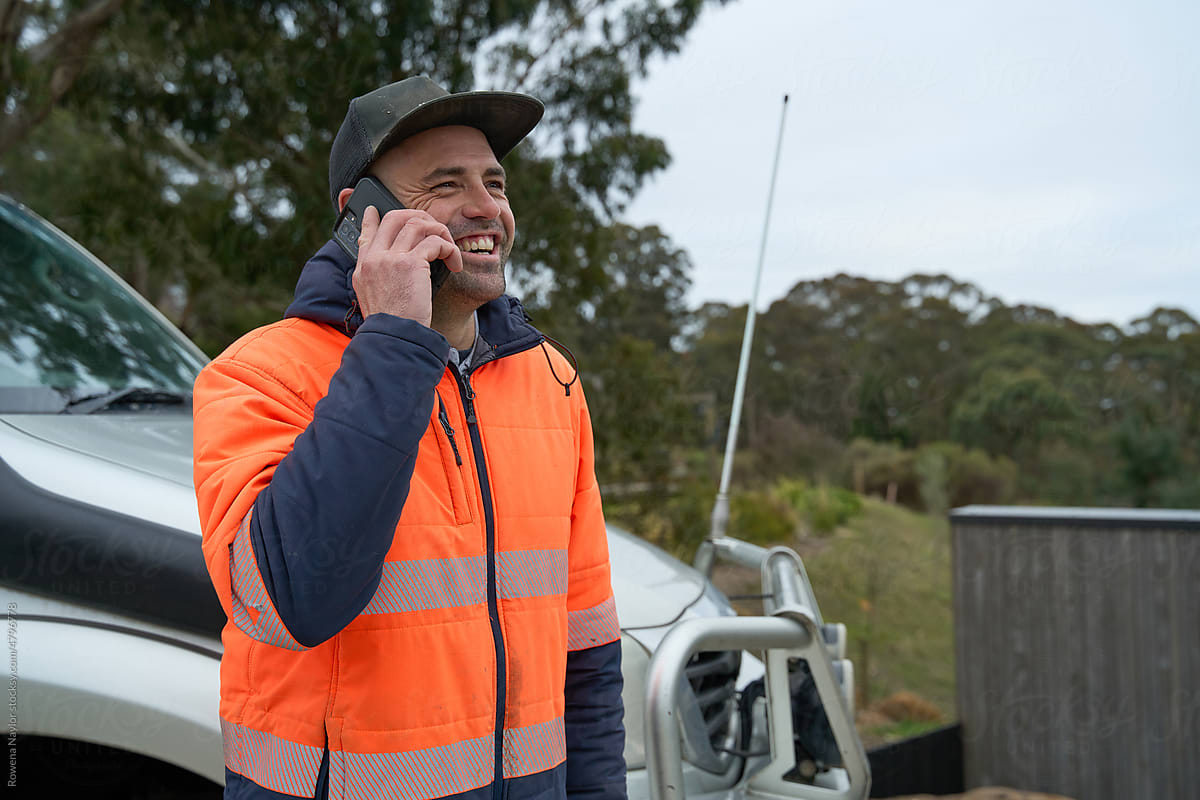Happy laughing tradesman on phone