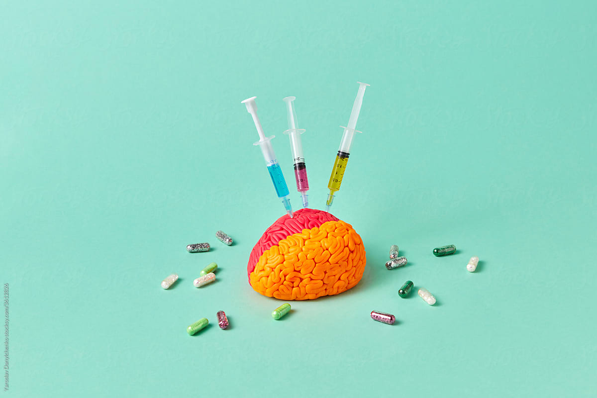 Colored brain with syringes and pills