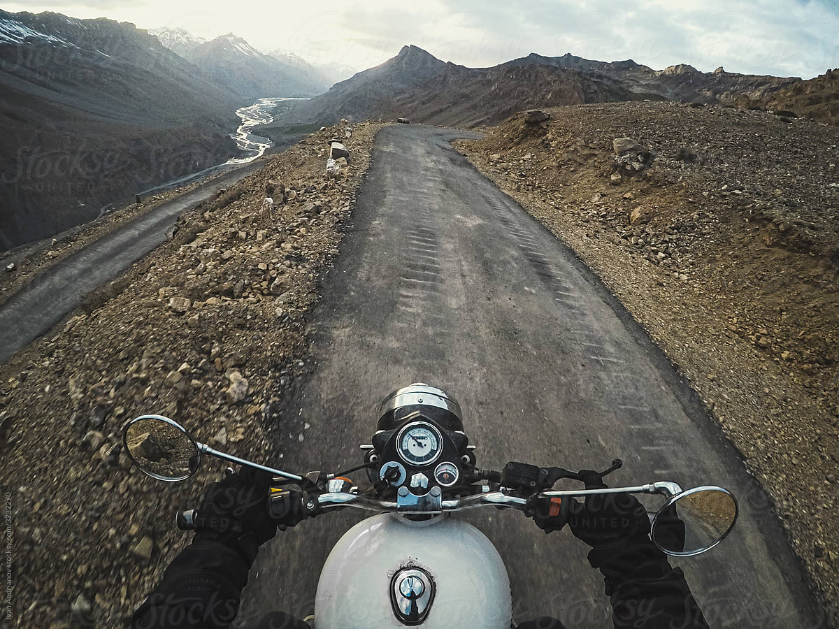 Traveling Biker Rides on Mountain Himalayas Road.