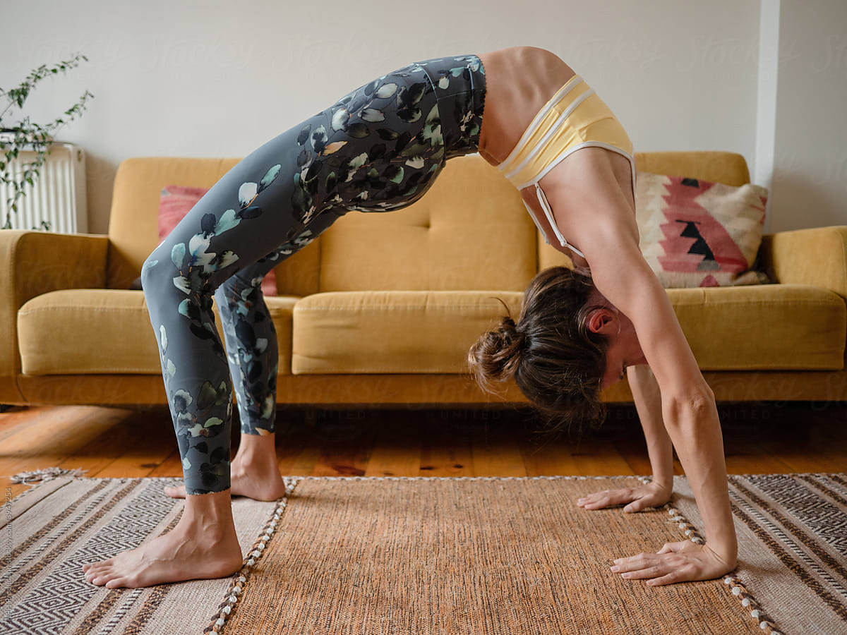 Relaxed woman doing yoga stretching at home