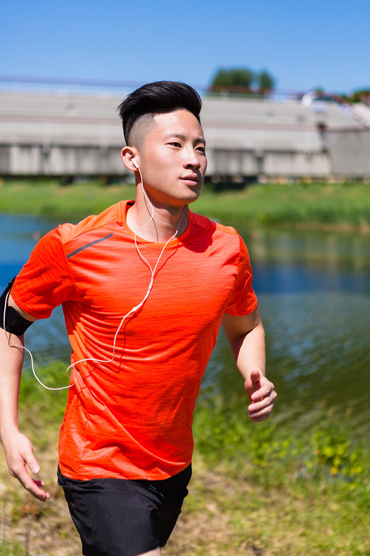 «Young Chinese Man Running In The City» del colaborador de Stocksy ...