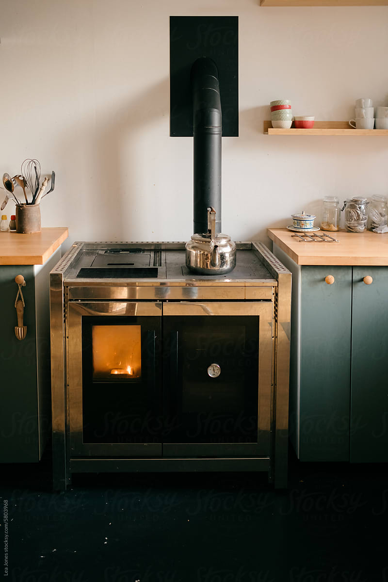 kettle on stove in modern farmhouse kitchen with wood stove