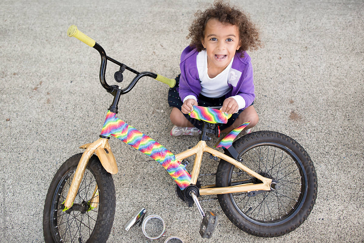 Laughing girl decorates bike