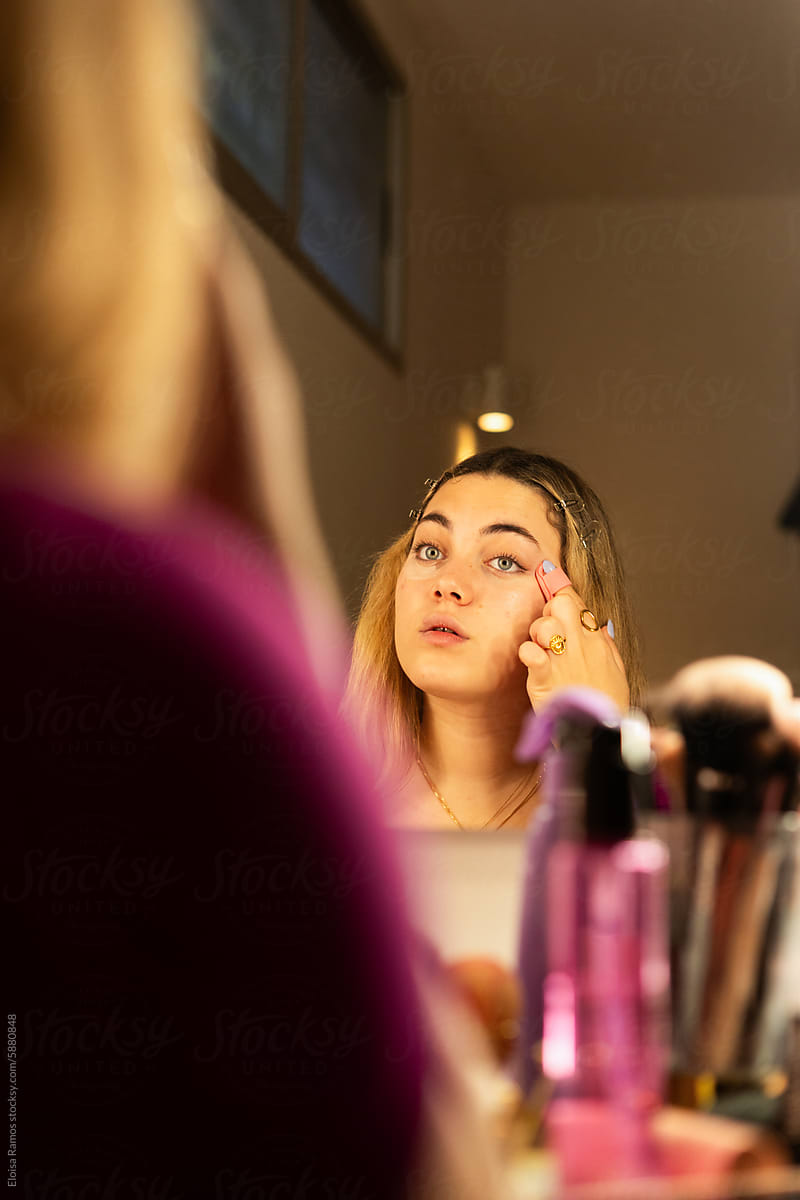 woman apllying concealer during makeup routine