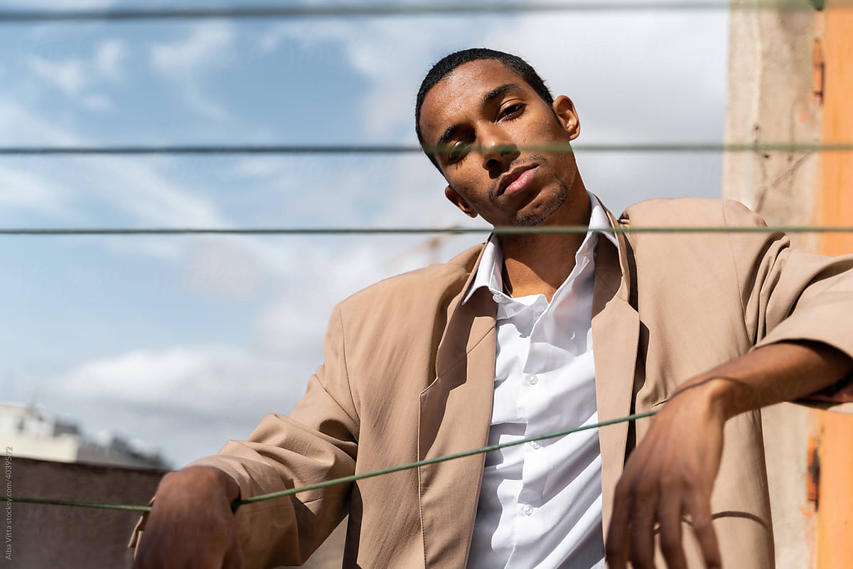 Fashion black man staring at camera on rooftop