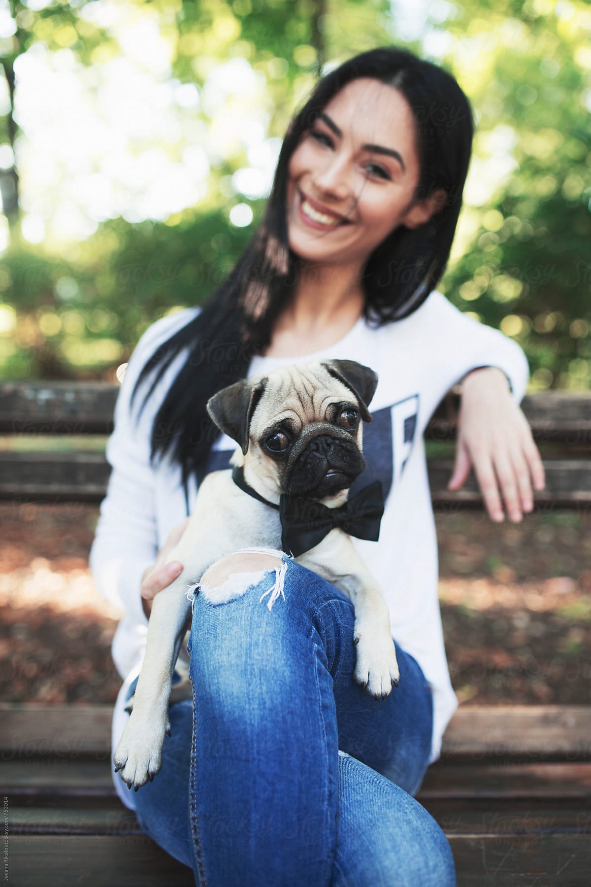 Young woman and her pet pug-dog