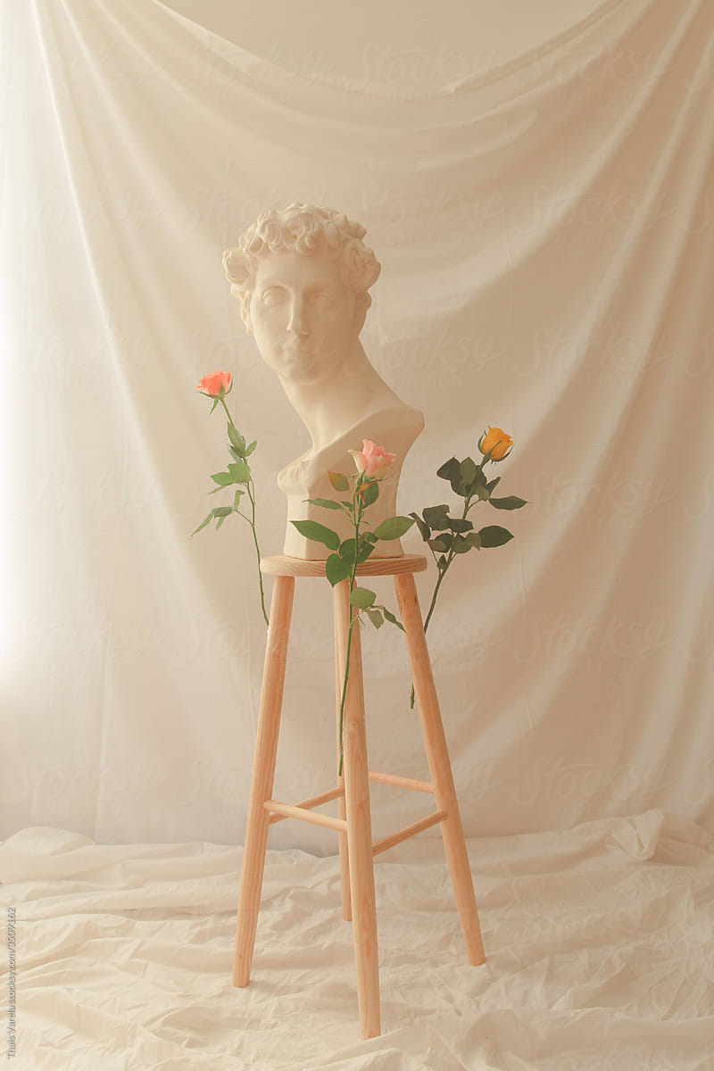 greek statue and roses.
