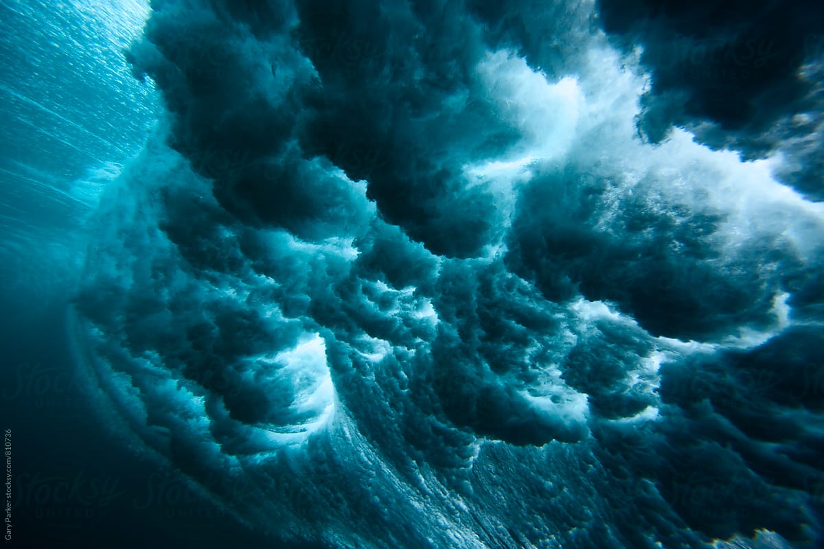 An underwater perspective of a breaking wave exploding above the surface