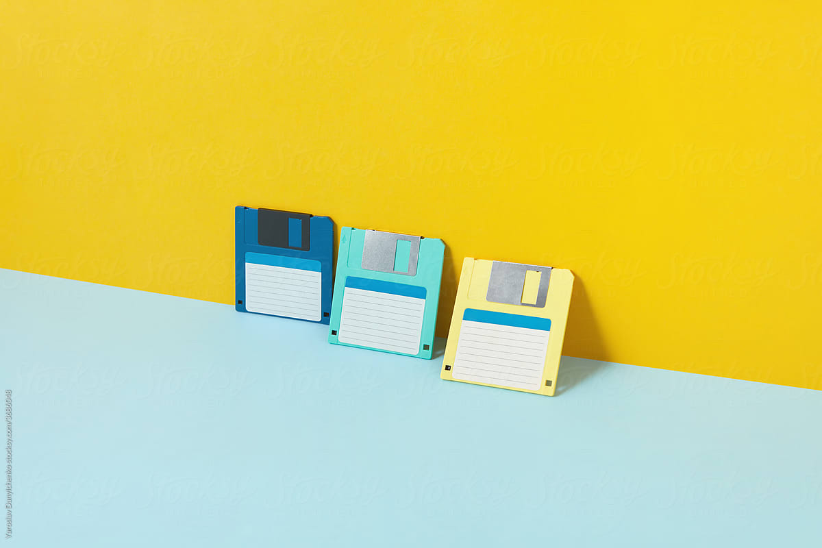 Colored old floppy disks over duotone background