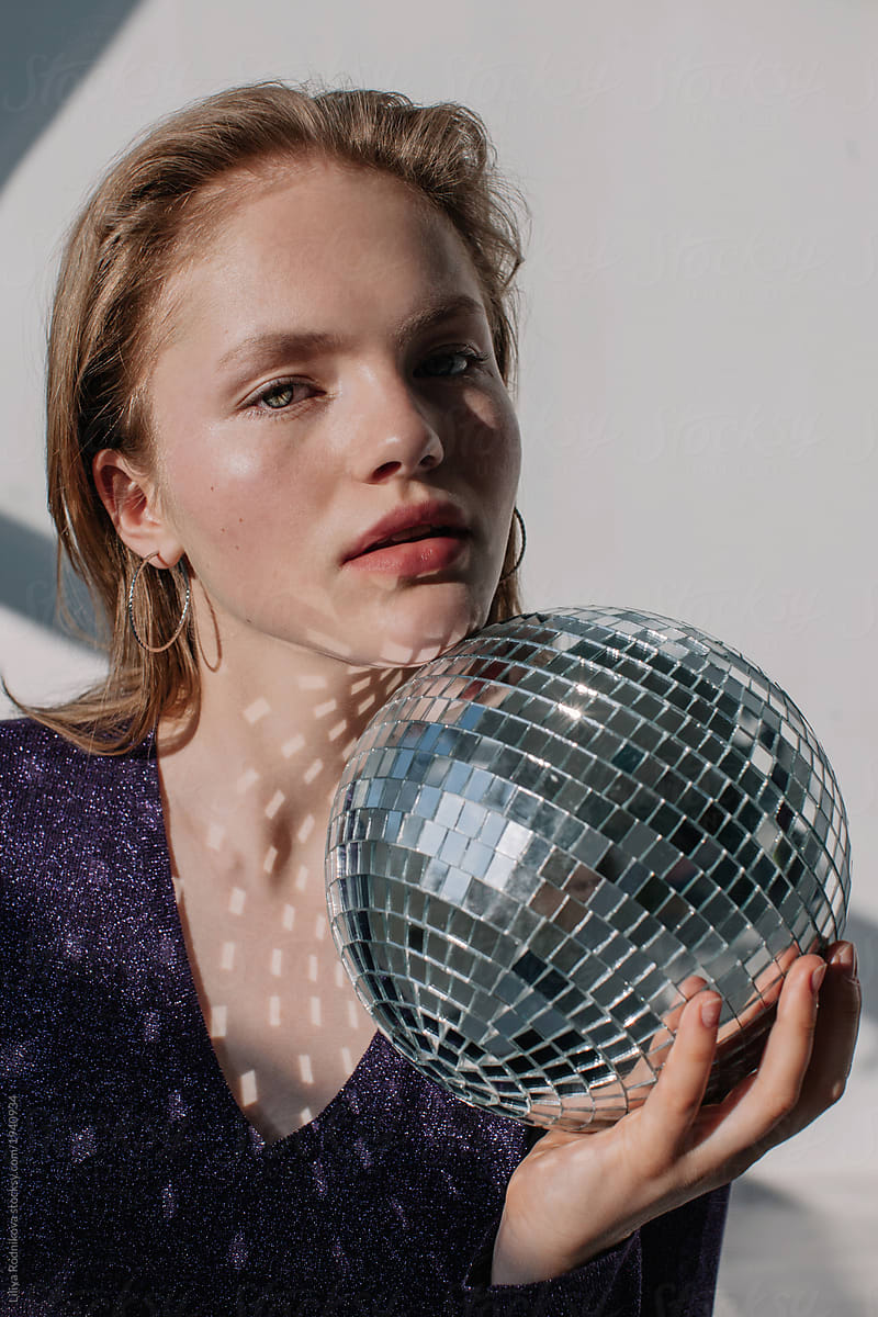 Amazing Blond Girl Posing Indoors With Disco Ball And Looking At Camera