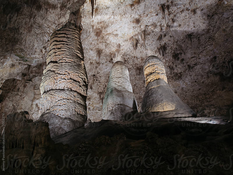 Three rock formations in dark underground cavern