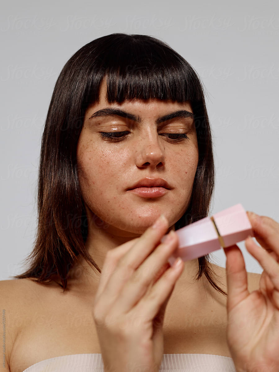 Woman checking out make up product ingredients