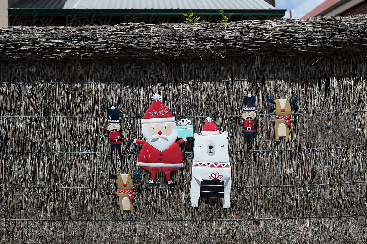 Christmas decorations on garden fence