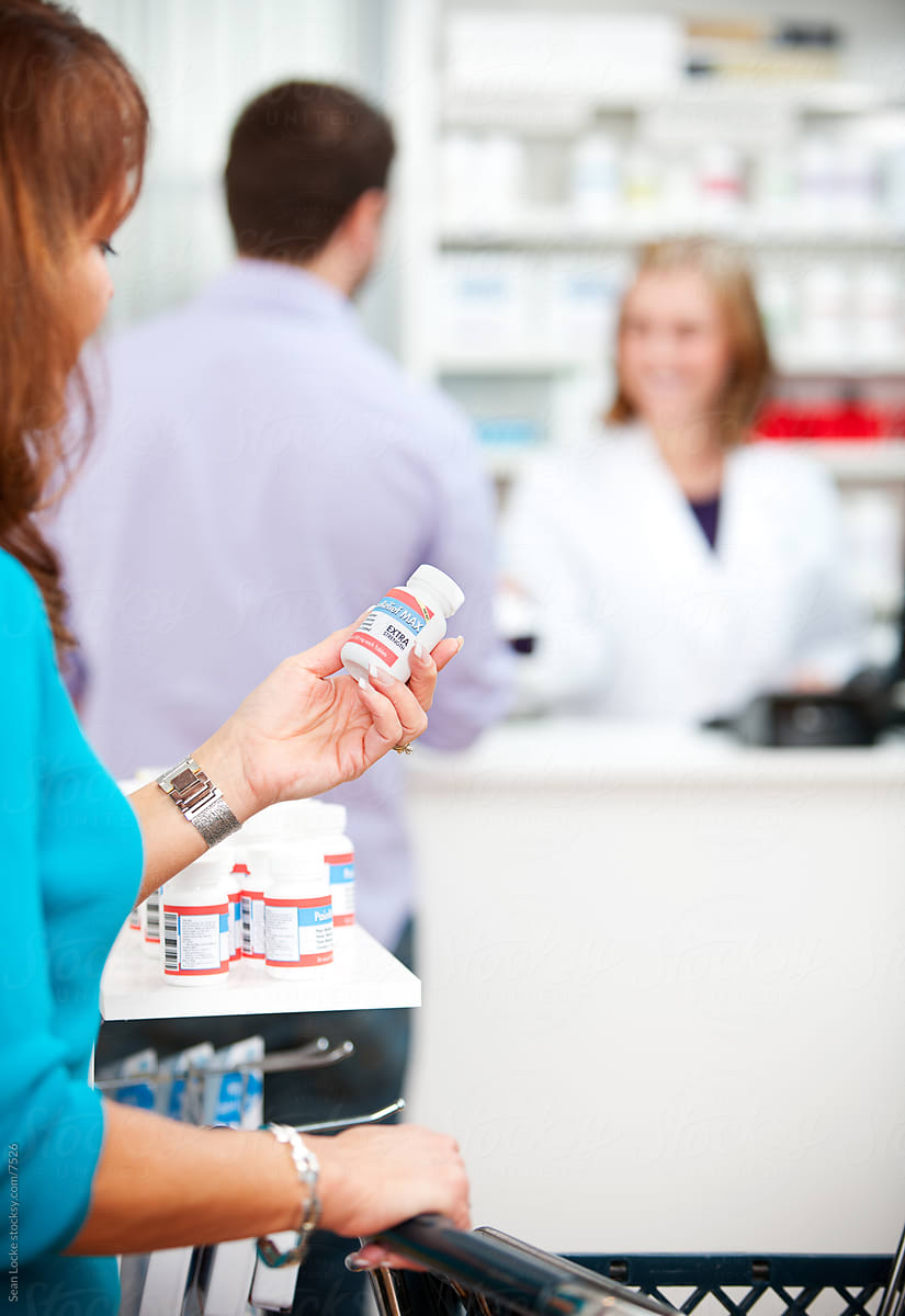 Pharmacy: Woman Reads Instructions on Pill Bottle
